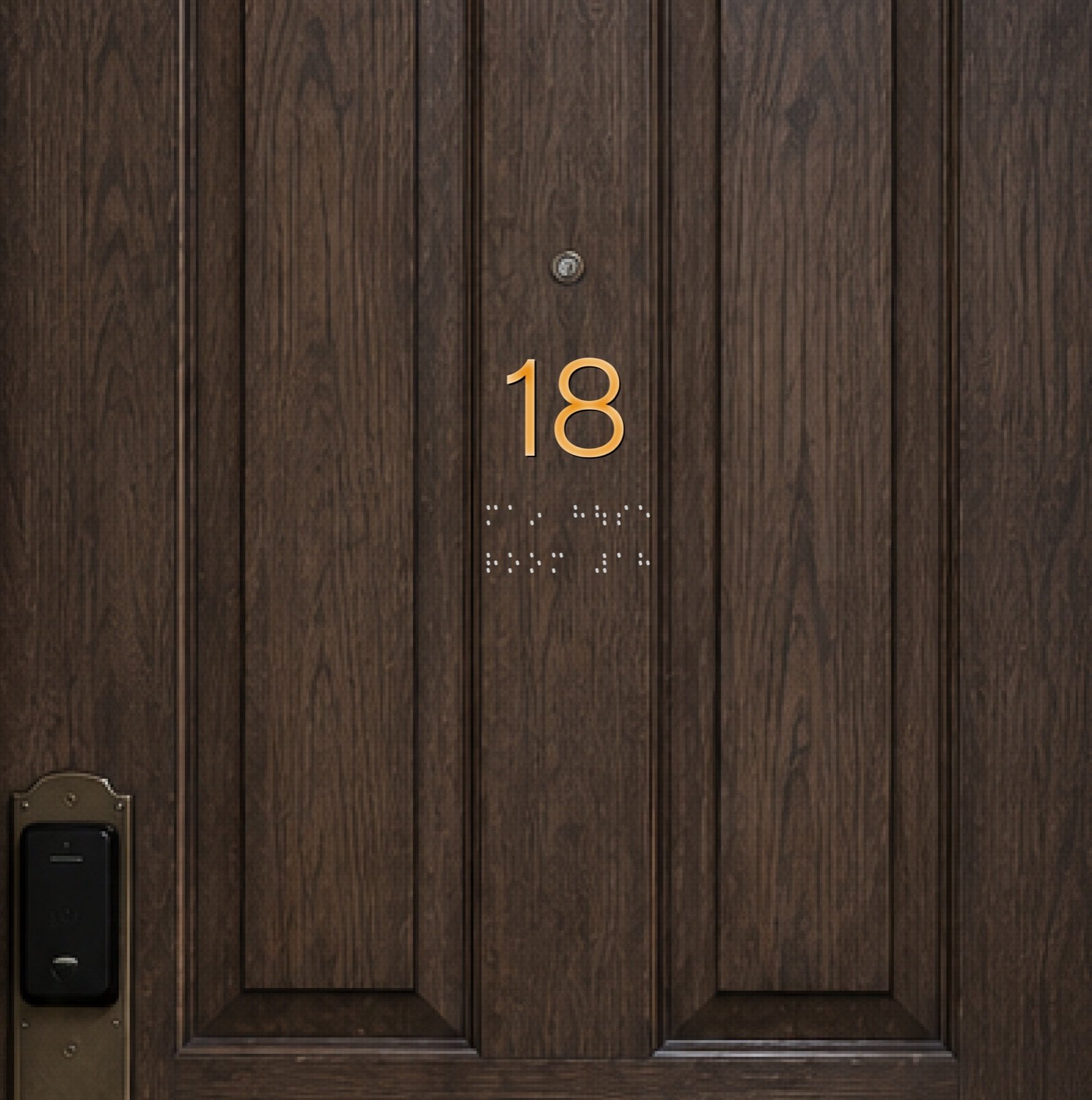 Close-up of a dark wood guest room door with the number eighteen in gold and braille dots beneath it