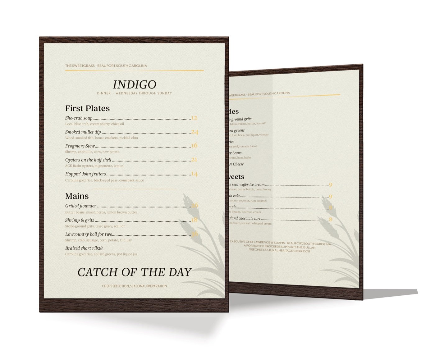 Dinner menus for Indigo, the Sweetgrass restaurant, in dark wood frames with sweetgrass illustrations and a Catch of the Day band